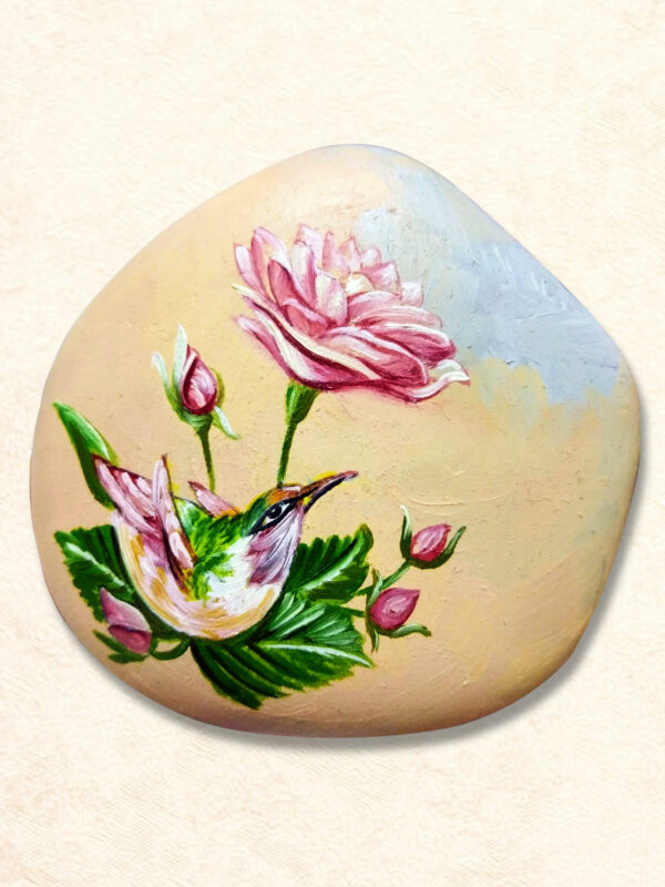 Decorative hand-painted stone paperweight featuring a colorful hummingbird surrounded by detailed flowers, perfect for home or office decor.
