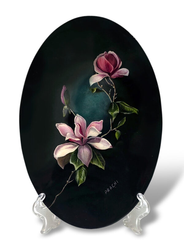 A black-themed magnolia flower painting representing elegance and inner strength on a stand